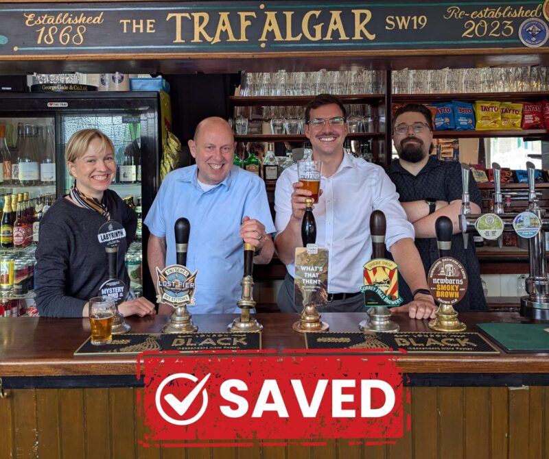 Cllr Ross Garrod, Cllr Ellie Stringer and Cllr Mike Brunt celebrating the victory with a pint at The Trafalgar Pub, 23 High Path, London, SW19
